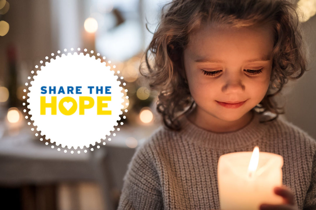 Small child holding candle with Share the hope graphic.