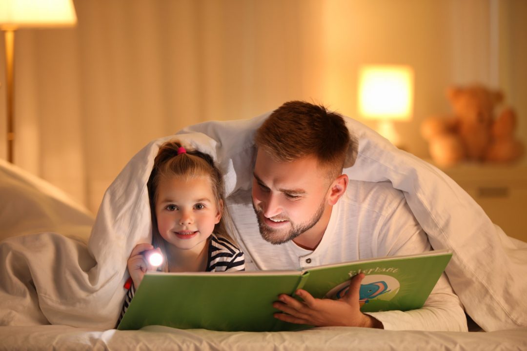 Father reading to daugher