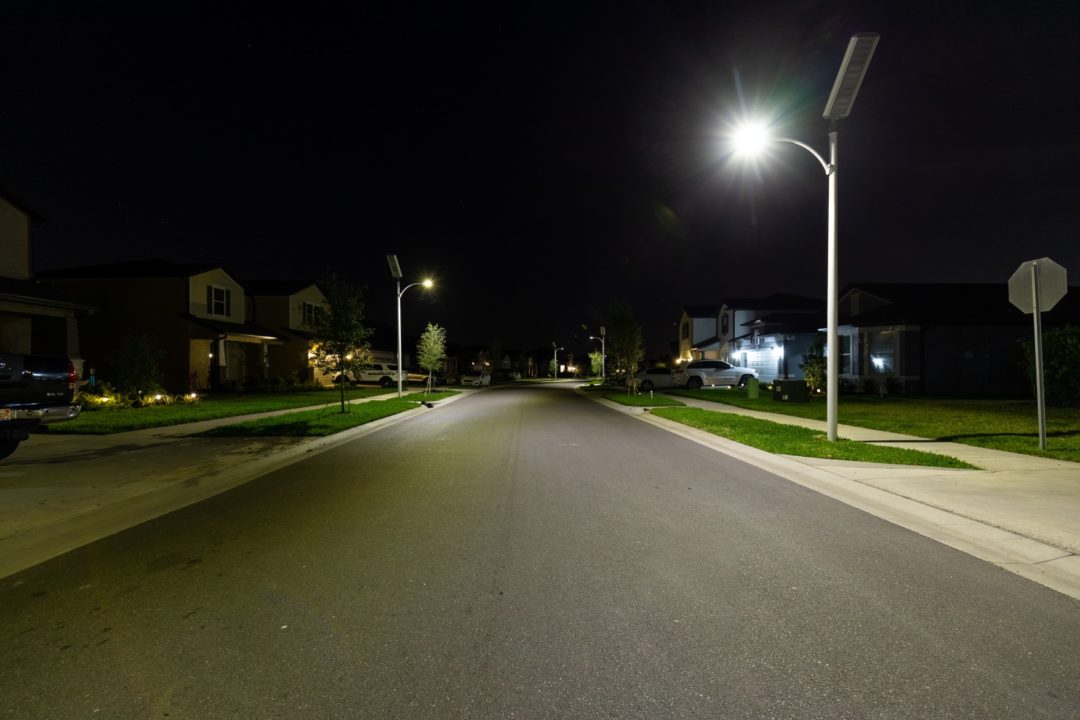 Solar panel street lights illuminating a street at night.