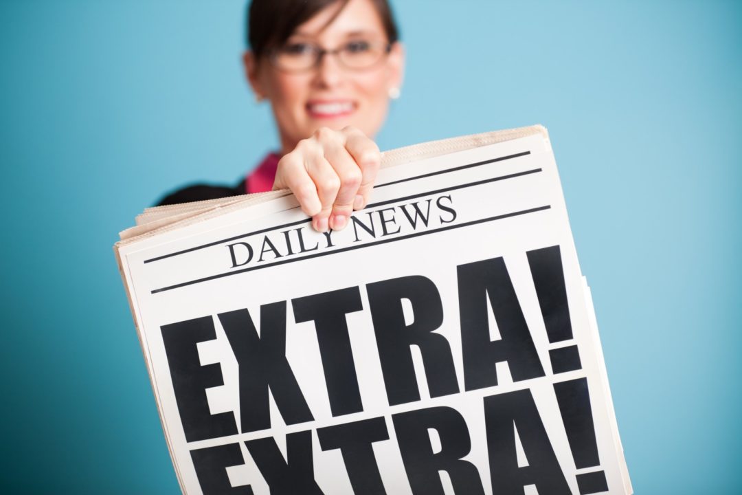 Woman holding newspaper, headline reads: Extra! Extra!